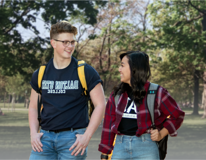 Male and female student with backpacks walking and smiling